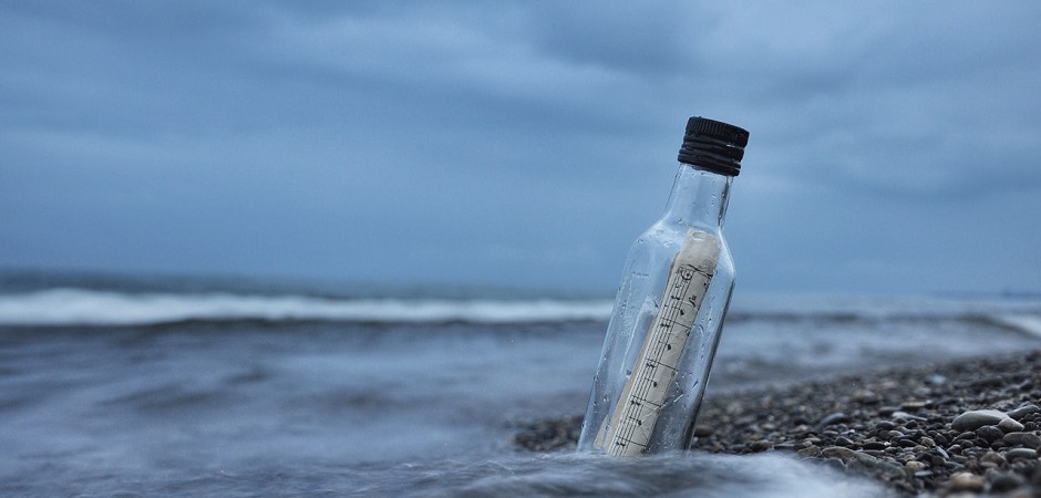Message in a bottle on the shoreline representing timely communication